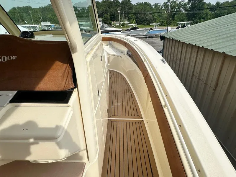 Slide: The Image of 2018 Scout 350 LXF boat deck with teak flooring and sleek design. - 22