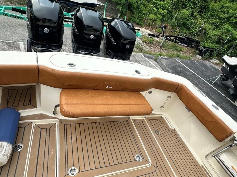 Slide: The Image of 2018 Scout 350 LXF boat interior with tan seating and multiple outboard engines. - 24