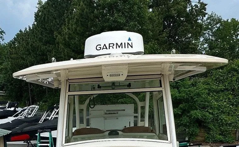 Slide: The Image of 2018 Scout 350 LXF boat with Garmin radar, surrounded by trees. - 27