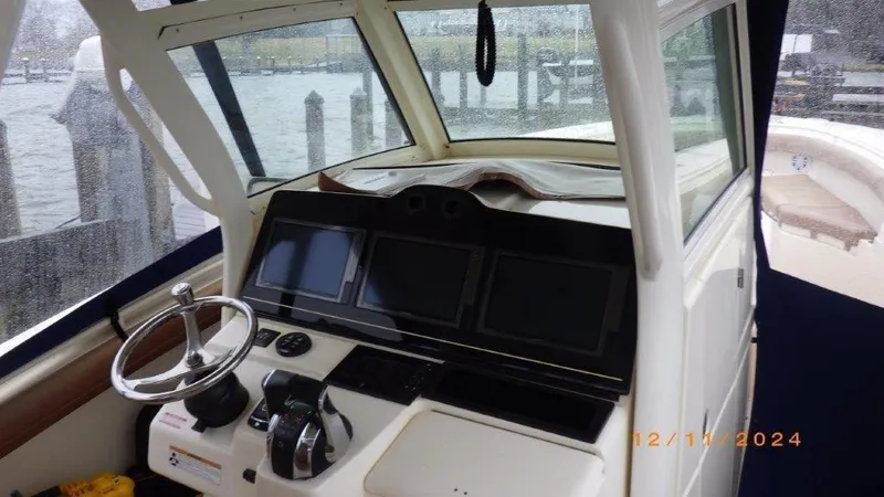 Slide: The Image of 2018 Scout 350 LXF boat helm with modern controls and navigation screens. - 33