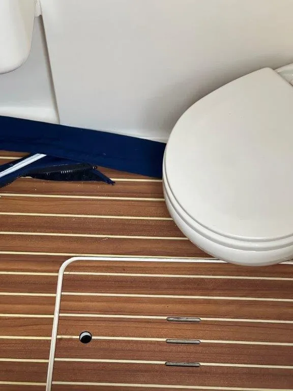 Slide: The Image of 2018 Scout 350 LXF boat interior with wooden flooring and white toilet. - 5