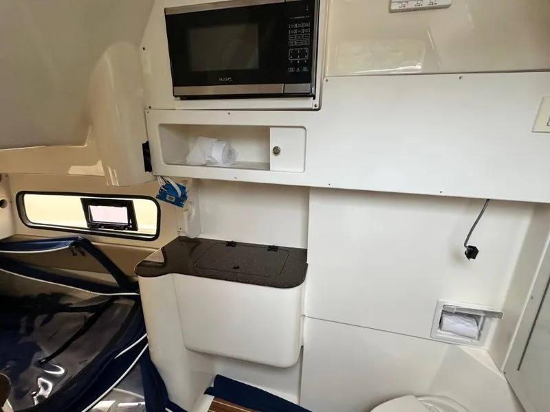 Slide: The Image of Interior of 2018 Scout 350 LXF boat with microwave and storage compartments. - 7