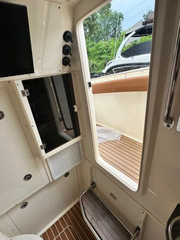 Slide: The Image of Interior view of 2018 Scout 350 LXF boat, featuring sleek design and wooden flooring. - 9