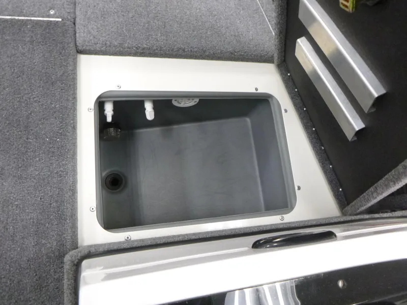 Slide: The Image of 2024 Ranger VS1782SC Angler boat storage compartment with gray interior and carpeted edges. - 11