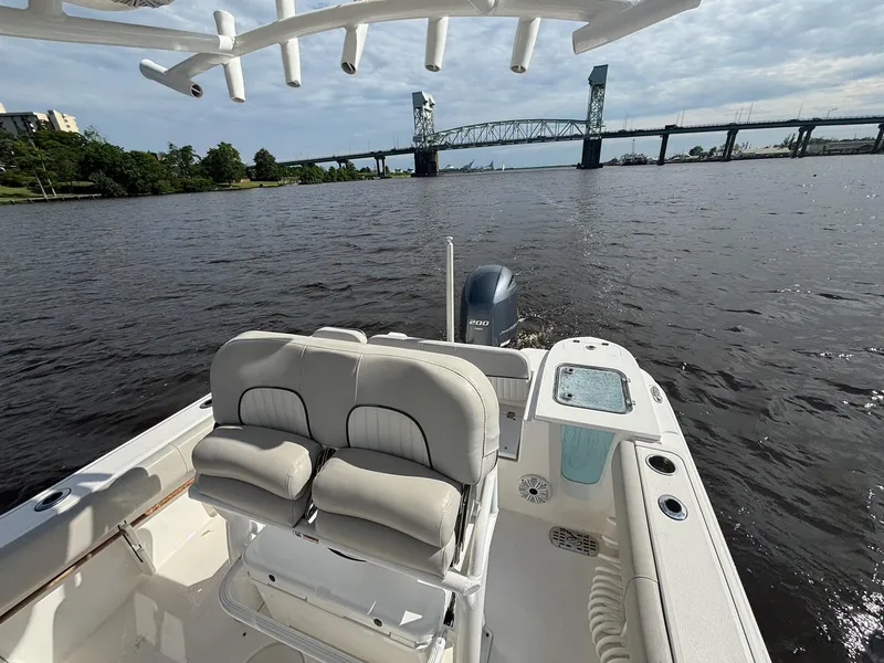 Slide: The Image of 2020 Sea Fox 228 Commander boat on water near a bridge, featuring comfortable seating. - 10
