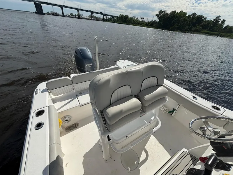 Slide: The Image of 2020 Sea Fox 228 Commander boat on water, featuring comfortable seating and scenic bridge view. - 11