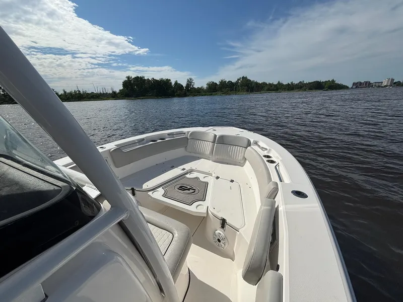 Slide: The Image of 2020 Sea Fox 228 Commander boat on calm water under a partly cloudy sky. - 7