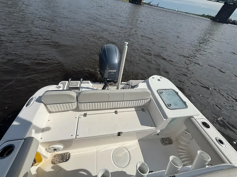 Slide: The Image of 2020 Sea Fox 228 Commander boat on water, featuring spacious deck and outboard motor. - 8