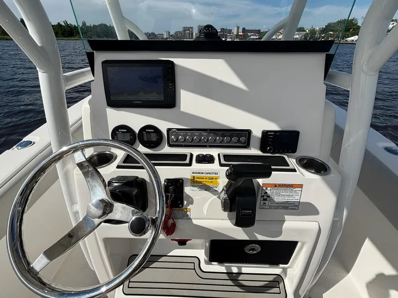 Slide: The Image of 2020 Sea Fox 228 Commander boat dashboard with steering wheel and navigation controls. - 9