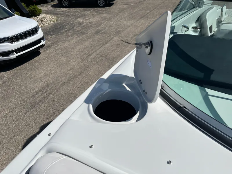 Slide: The Image of 2026 Crownline 298 SS boat with open storage compartment on deck. - 10