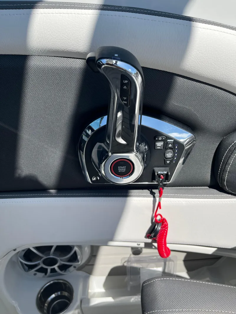 Slide: The Image of Throttle control of 2026 Crownline 298 SS boat with sleek design and red safety lanyard. - 22