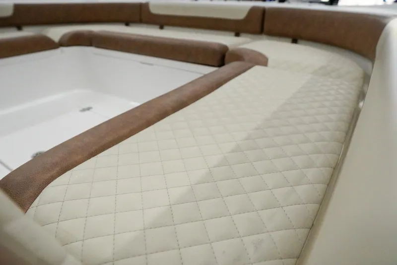 Slide: The Image of 2020 Caymas 26 HB boat interior with quilted seating and storage compartment. - 11