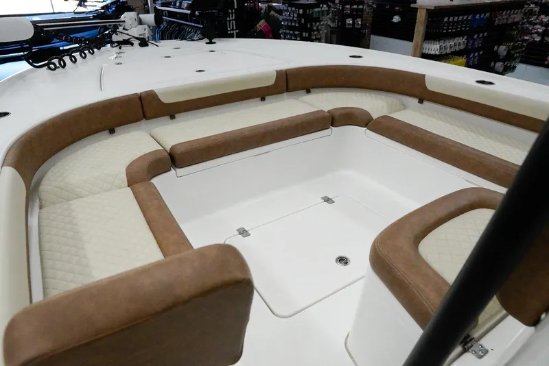 Slide: The Image of 2020 Caymas 26 HB boat interior with cushioned seating and storage compartments. - 13