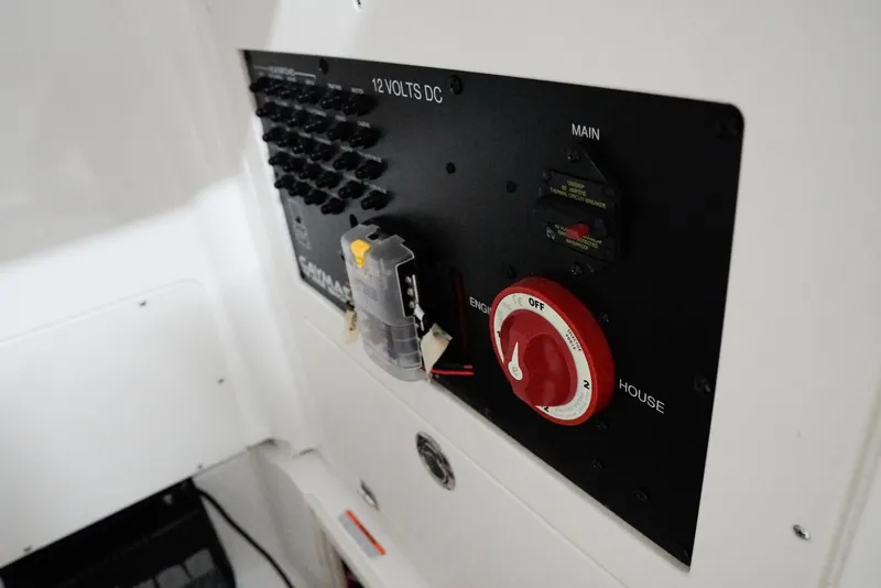 Slide: The Image of Electrical panel of 2020 Caymas 26 HB boat with switches and controls. - 15