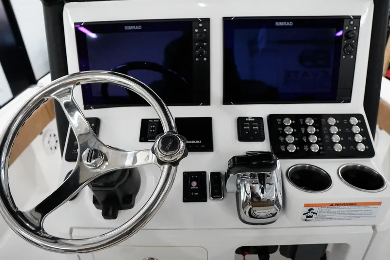 Slide: The Image of Control panel of 2020 Caymas 26 HB boat with dual Simrad displays and steering wheel. - 17