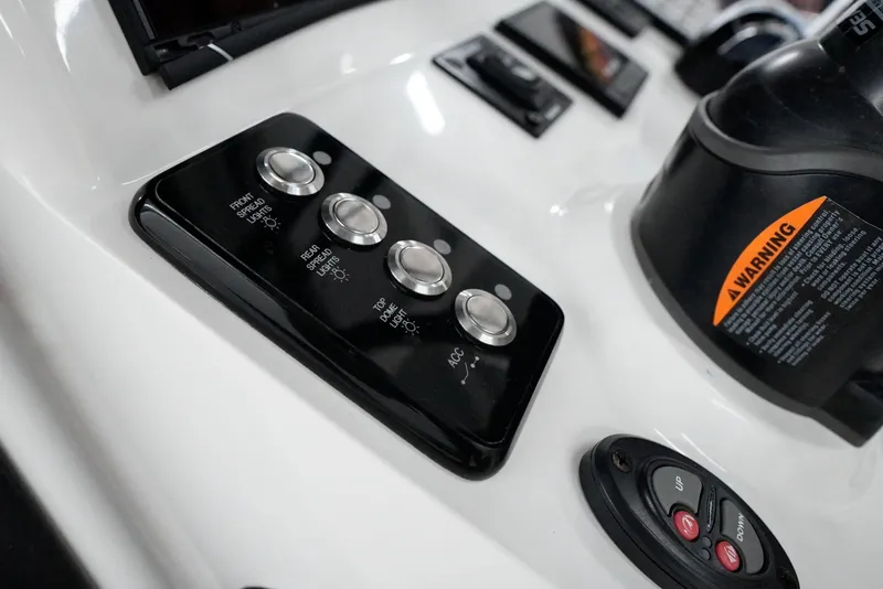 Slide: The Image of Control panel of a 2020 Caymas 26 HB boat with labeled buttons and warning label. - 18