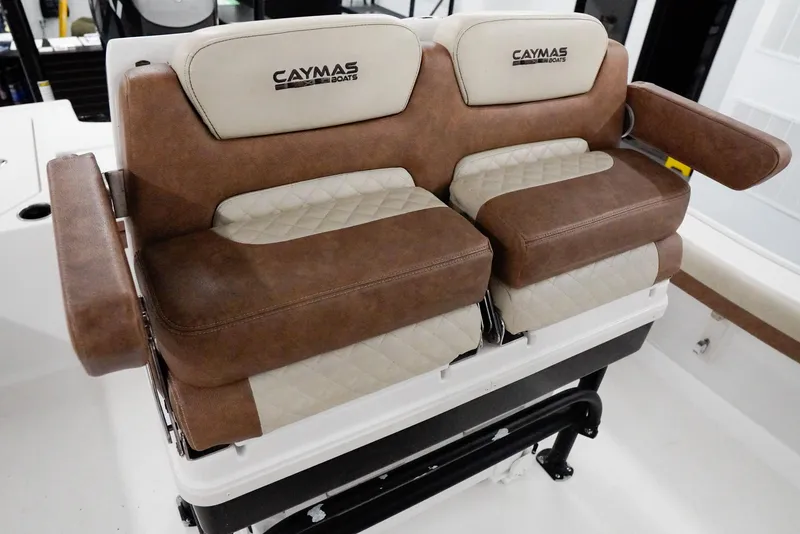 Slide: The Image of Caymas 26 HB 2020 boat seats with brown and beige upholstery, featuring armrests. - 21