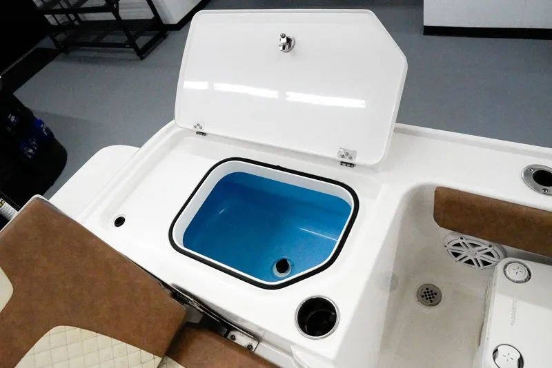 Slide: The Image of 2020 Caymas 26 HB boat livewell with open lid and blue interior. - 24