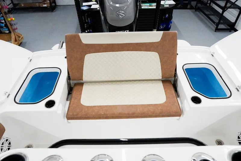Slide: The Image of 2020 Caymas 26 HB boat interior with cushioned seating and storage compartments. - 26