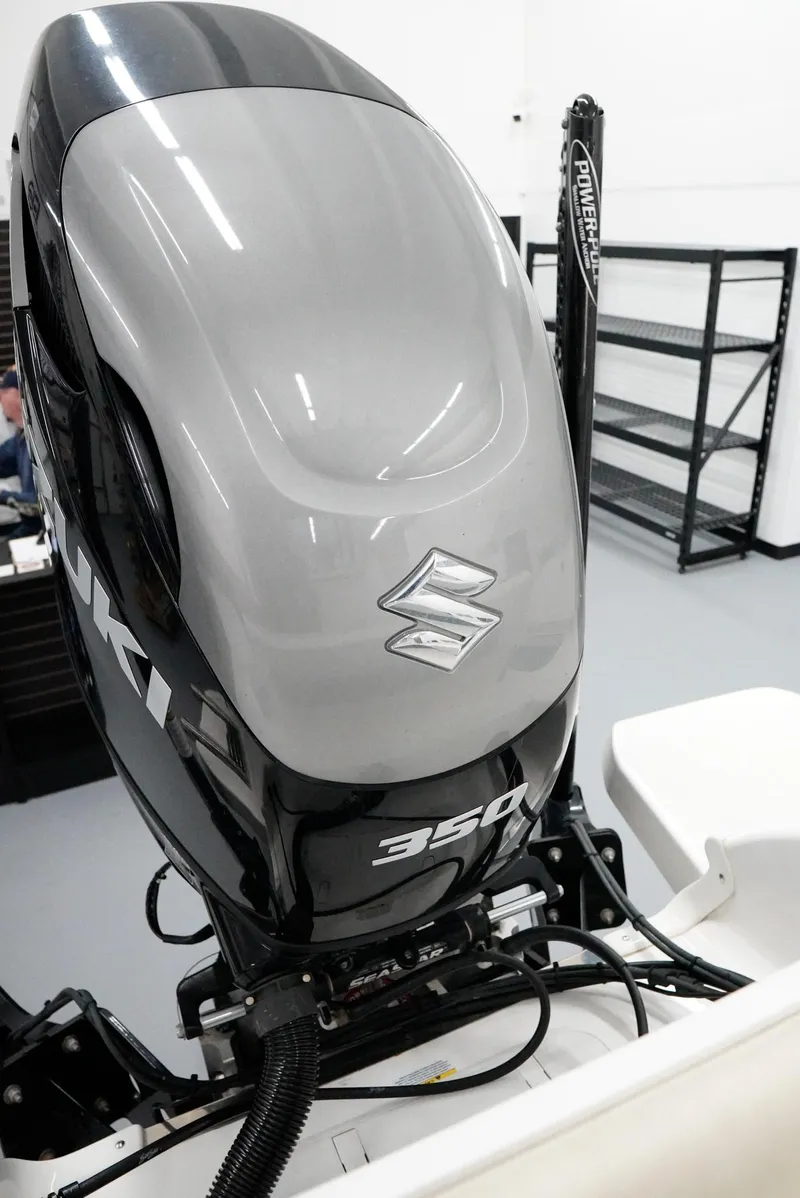 Slide: The Image of Suzuki 350 outboard motor on a 2020 Caymas 26 HB boat in a showroom. - 27
