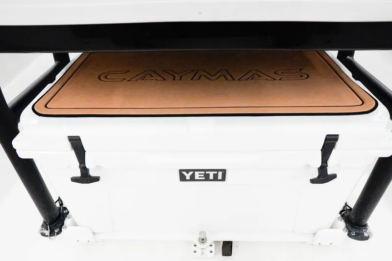 Slide: The Image of White YETI cooler under Caymas 26 HB boat seat, 2020 model. - 28