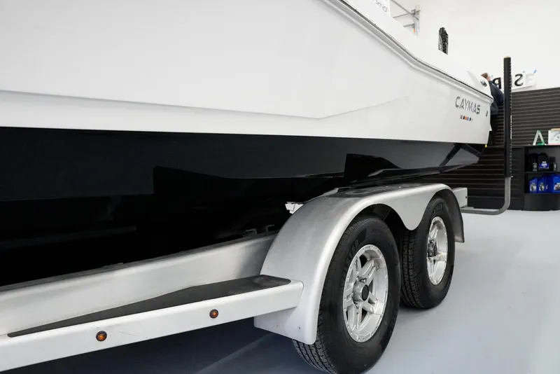 Slide: The Image of 2020 Caymas 26 HB boat on trailer in showroom. - 5