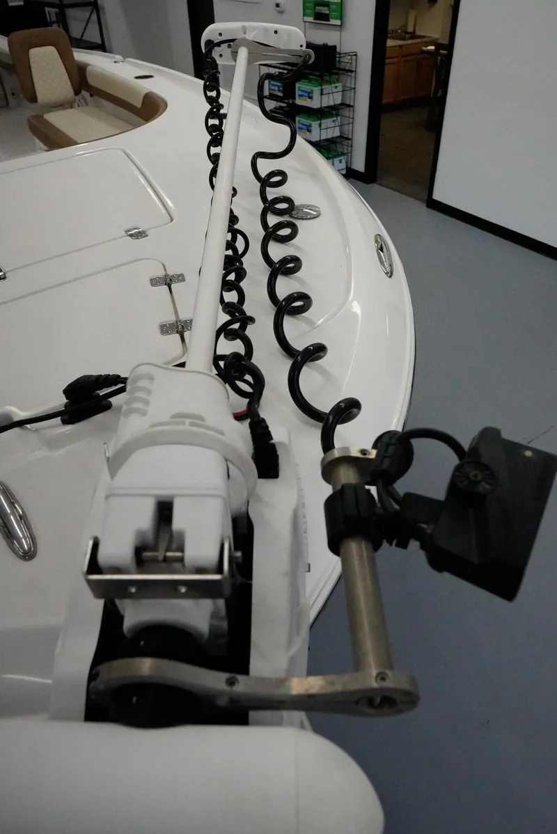 Slide: The Image of 2020 Caymas 26 HB boat with trolling motor and coiled cable on deck. - 7