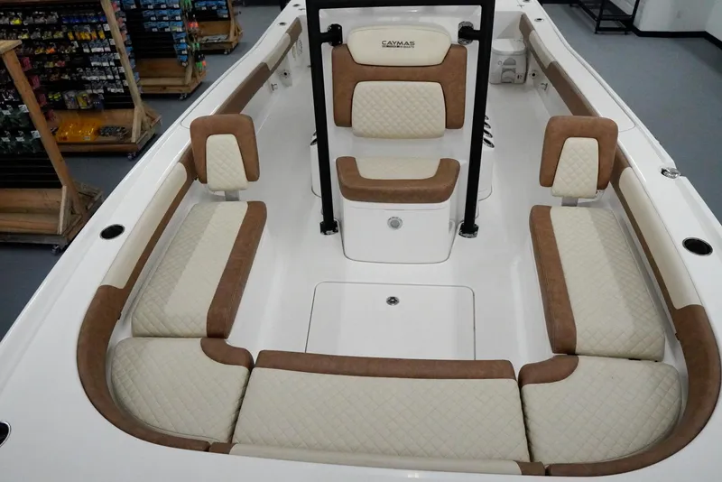 Slide: The Image of 2020 Caymas 26 HB boat interior with cushioned seating and storage compartments. - 9