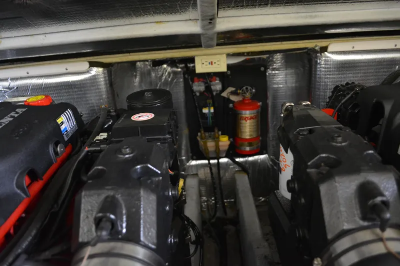 Slide: The Image of Engine compartment of a 2004 Carolina Classic 28 boat, featuring dual engines and safety equipment. - 15