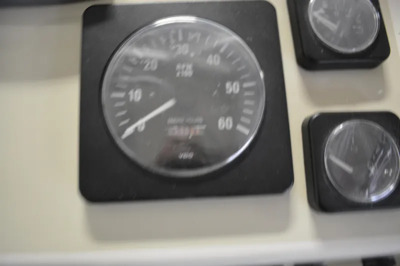 Slide: The Image of Dashboard gauges of a 2004 Carolina Classic 28 boat, featuring speedometer and dials. - 18