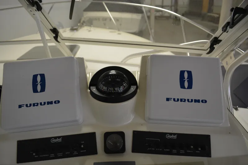 Slide: The Image of 2004 Carolina Classic 28 boat dashboard with Furuno equipment and compass. - 24
