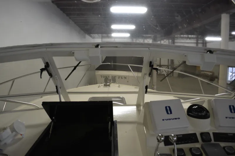 Slide: The Image of 2004 Carolina Classic 28 boat cockpit with navigation equipment in an indoor setting. - 25