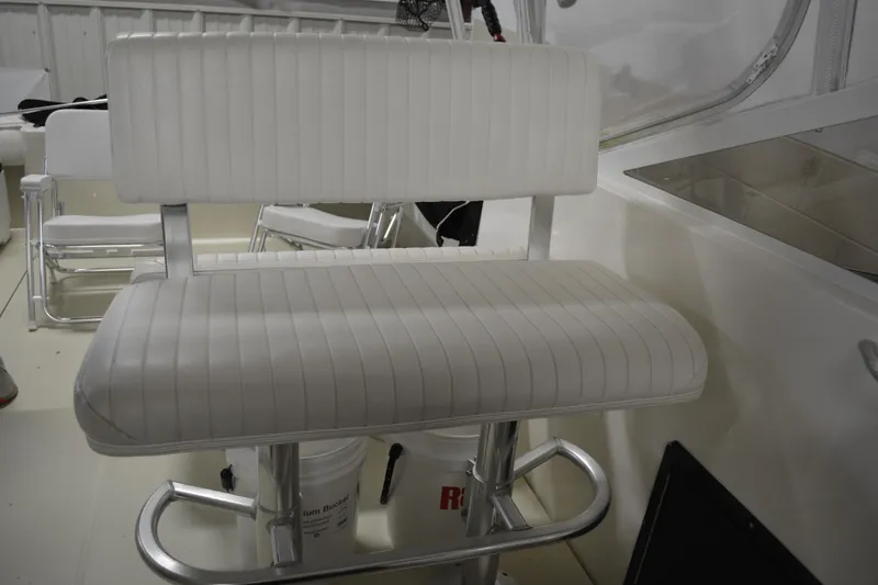 Slide: The Image of White cushioned seat on 2004 Carolina Classic 28 boat interior. - 26