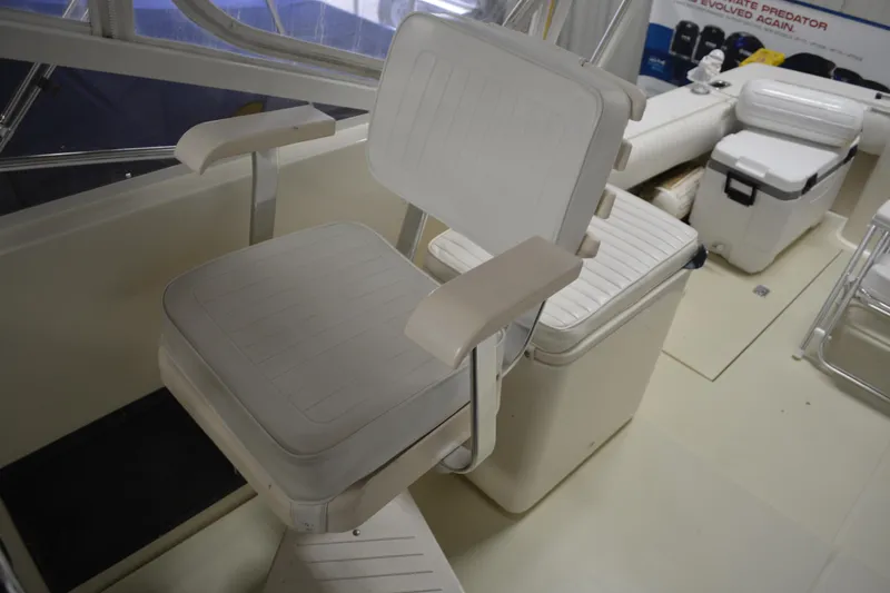 Slide: The Image of Captain's chair on a 2004 Carolina Classic 28 boat, featuring white cushioned seating. - 27