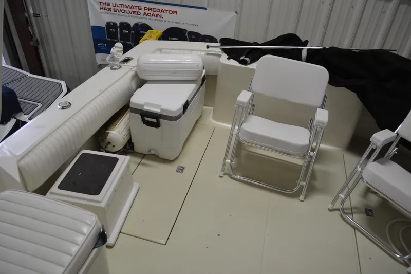 Slide: The Image of 2004 Carolina Classic 28 boat interior with seating and storage compartments. - 29