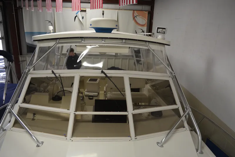 Slide: The Image of 2004 Carolina Classic 28 boat, front view in a showroom with American flags above. - 3