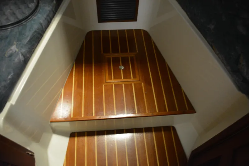 Slide: The Image of 2004 Carolina Classic 28 cabin interior with polished wooden flooring. - 35