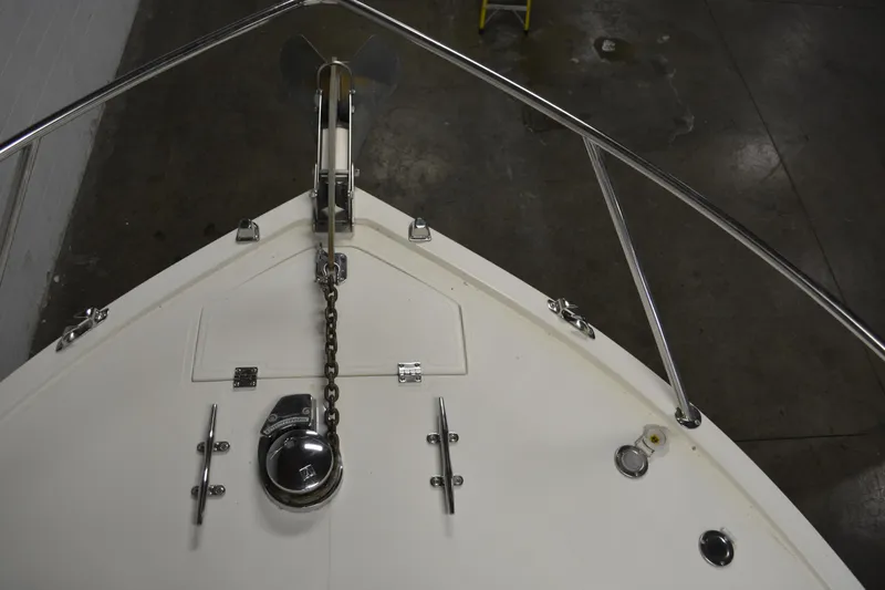 Slide: The Image of Bow of 2004 Carolina Classic 28 boat with anchor chain and railing in a warehouse. - 6