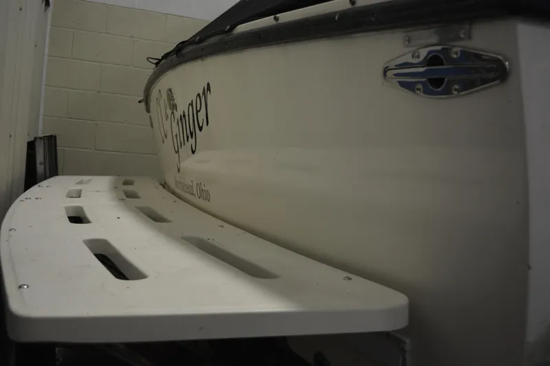 Slide: The Image of 2004 Carolina Classic 28 boat with swim platform, docked indoors. - 9