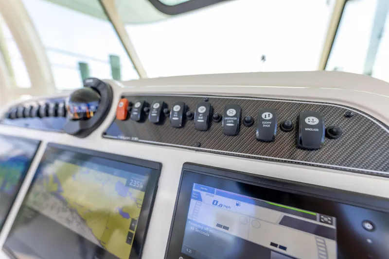 Slide: The Image of Control panel of 2022 Grady-White Canyon 336 boat with navigation screens and switches. - 15
