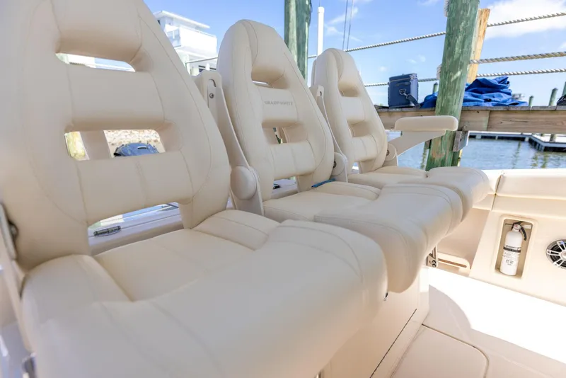 Slide: The Image of 2022 Grady-White Canyon 336 boat seats, beige leather, docked at marina. - 18