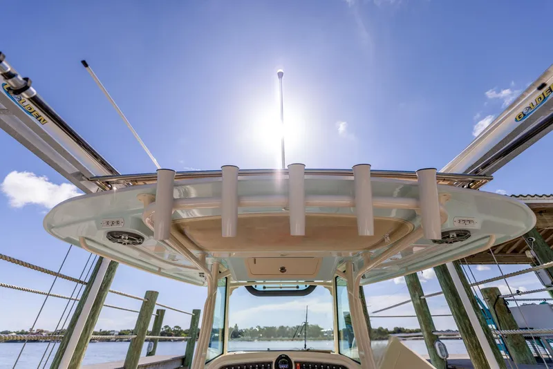 Slide: The Image of 2022 Grady-White Canyon 336 boat with sunlit T-top and rod holders. - 27