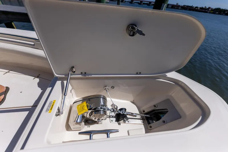 Slide: The Image of Open anchor locker on 2022 Grady-White Canyon 336 boat, showing anchor and winch. - 31