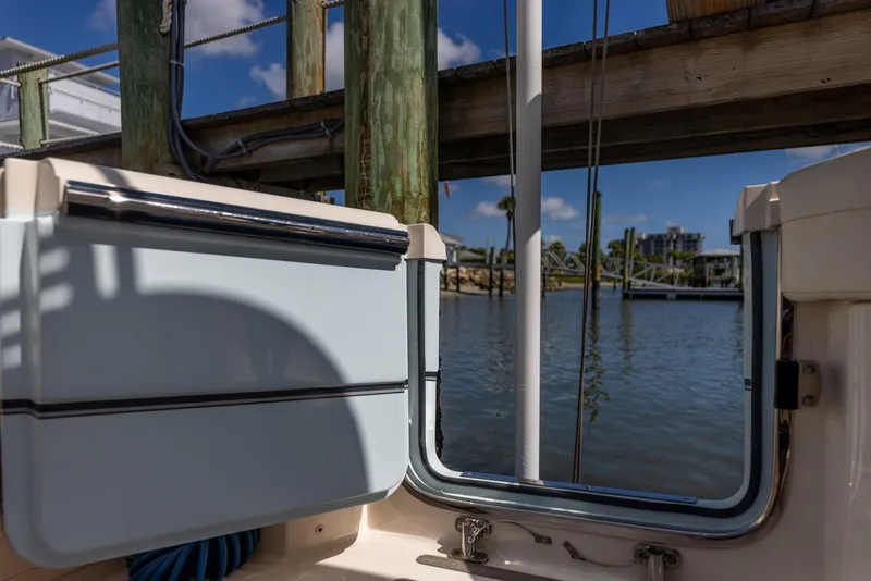 Slide: The Image of 2022 Grady-White Canyon 336 boat docked by a serene waterfront. - 40