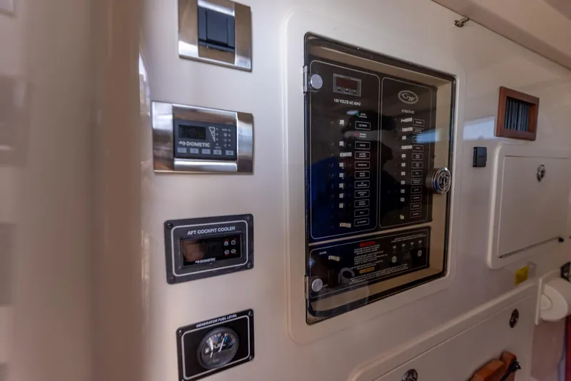 Slide: The Image of Control panel of 2022 Grady-White Canyon 336 boat, featuring various switches and displays. - 42