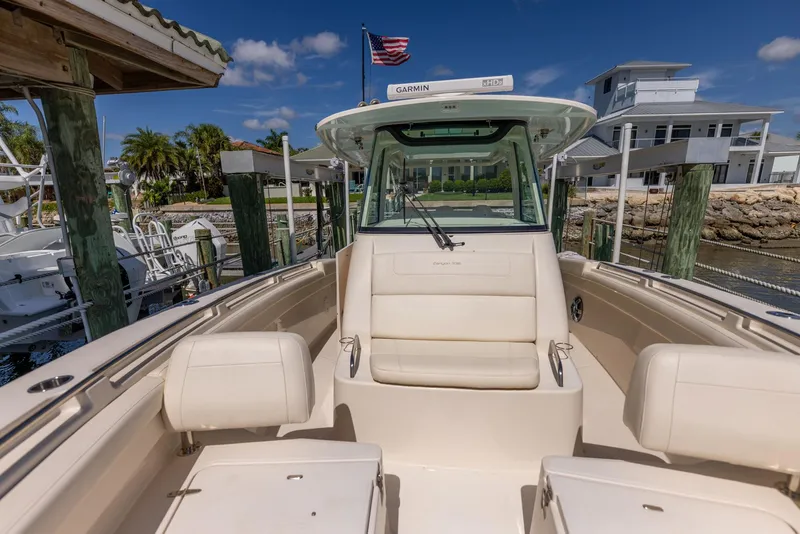 Slide: The Image of 2022 Grady-White Canyon 336 boat docked, featuring spacious seating and modern design. - 46