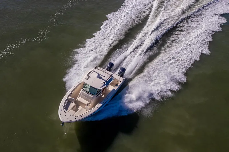 Slide: The Image of 2022 Grady-White Canyon 336 boat cruising on open water, aerial view. - 5
