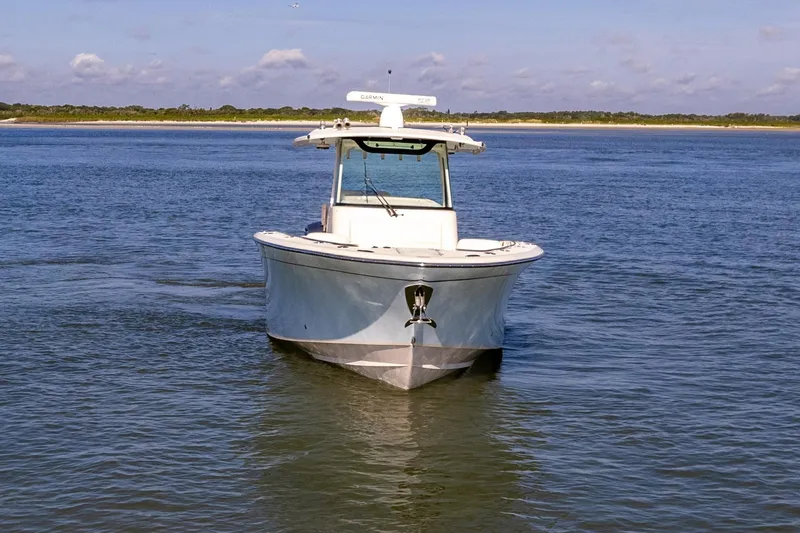Slide: The Image of 2022 Grady-White Canyon 336 boat cruising on calm waters under a clear sky. - 8