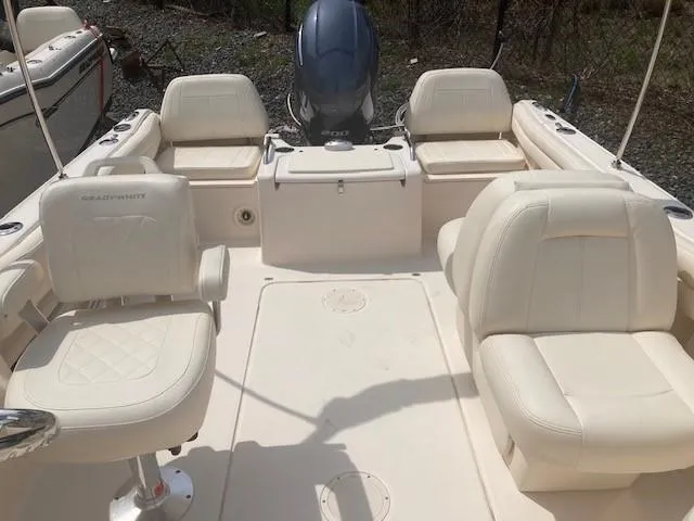 Slide: The Image of 2022 Grady-White Freedom 215 boat interior with white seating and motor. - 4