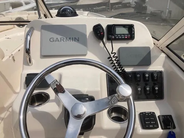 Slide: The Image of Steering console of 2022 Grady-White Freedom 215 boat with Garmin navigation system. - 5